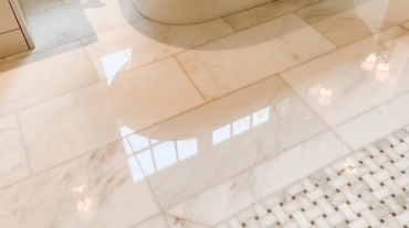 a white bathtub on a marble floor