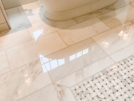 a white bathtub on a marble floor